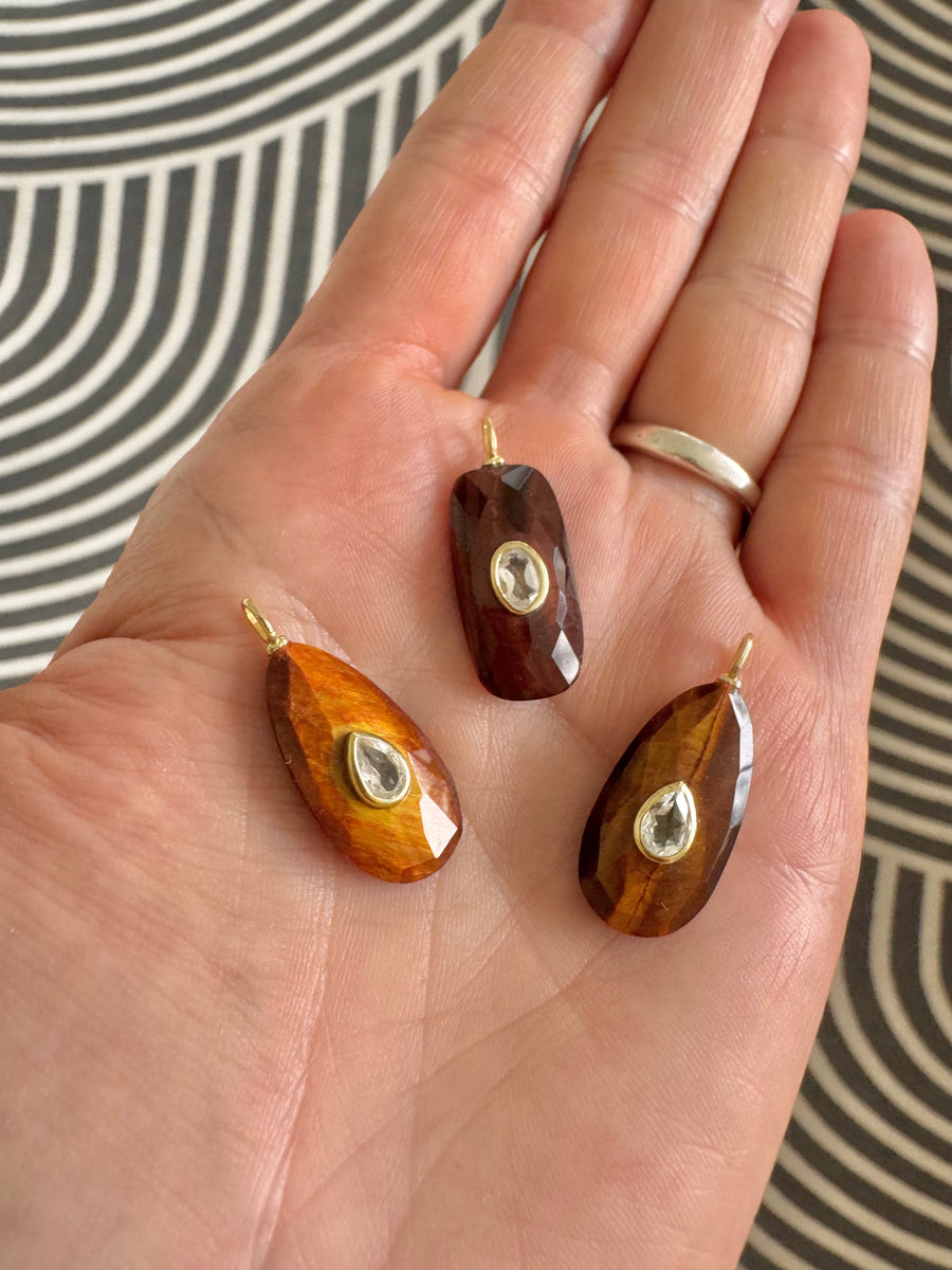 Stunning red tiger eye carved charm with white topaz accent