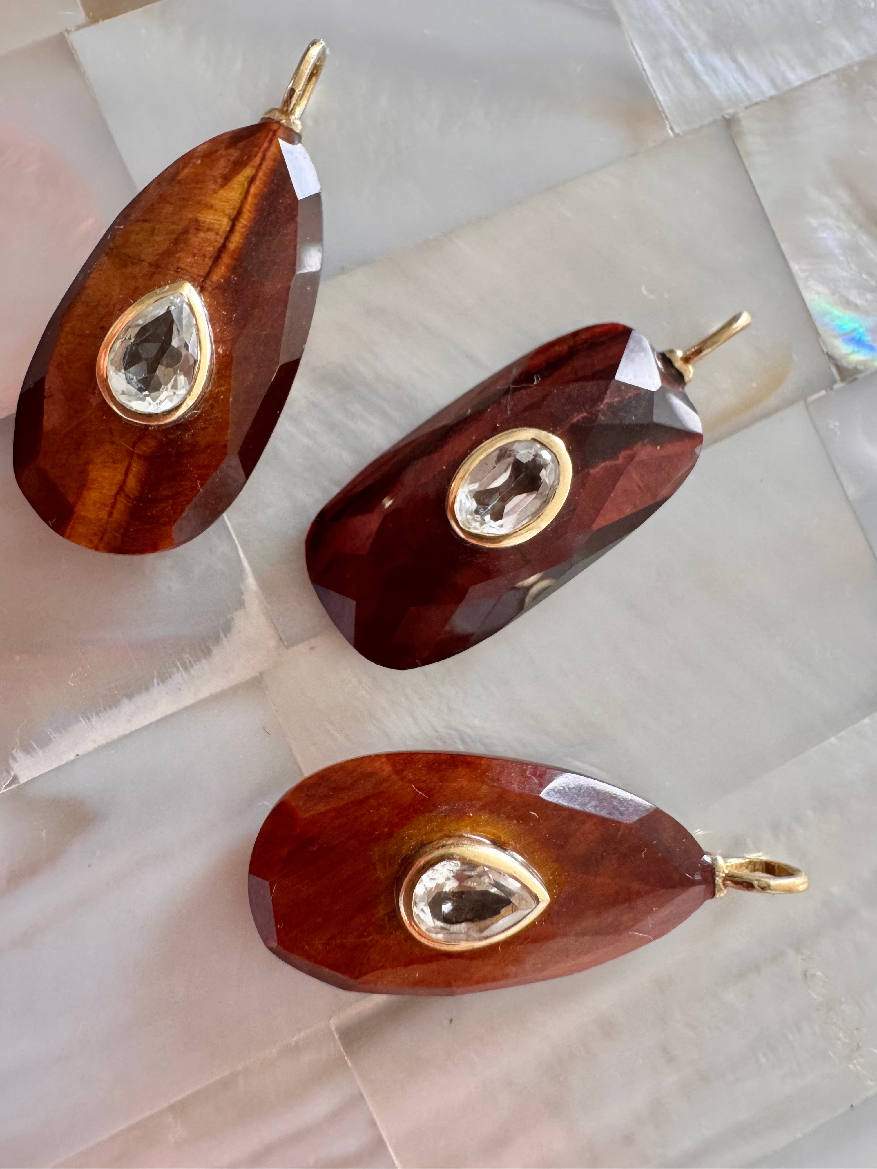 Stunning red tiger eye carved charm with white topaz accent